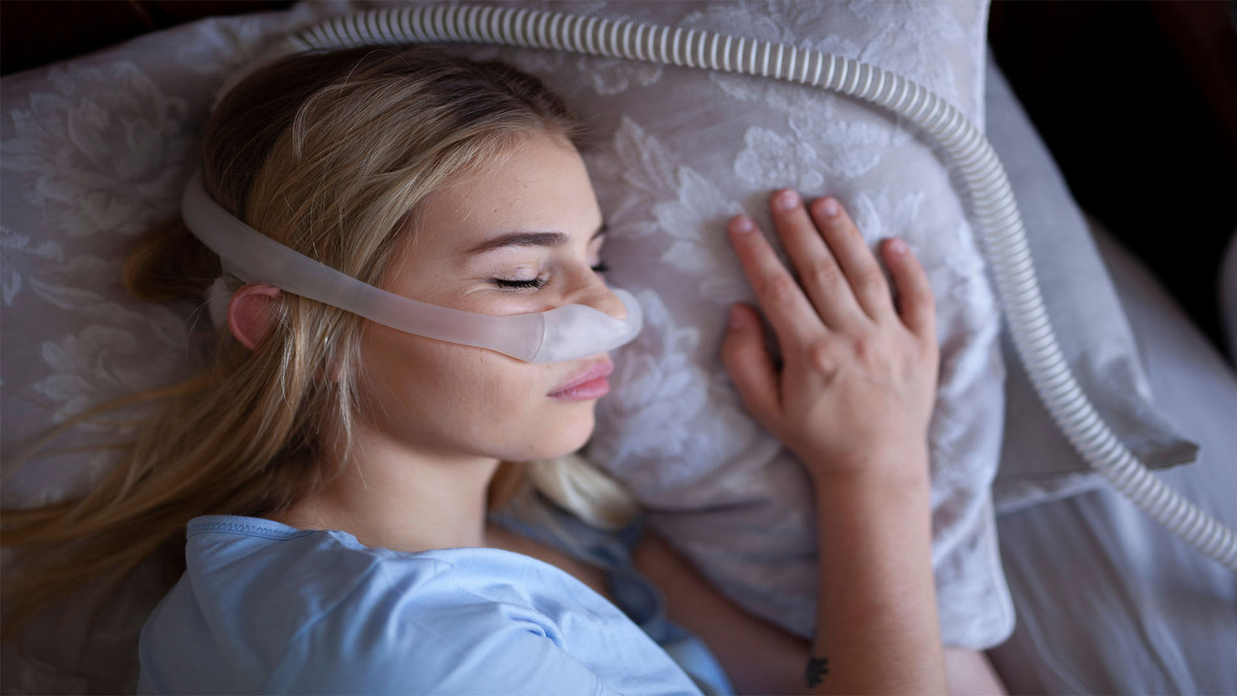 Woman sleeping with a CPAP mask