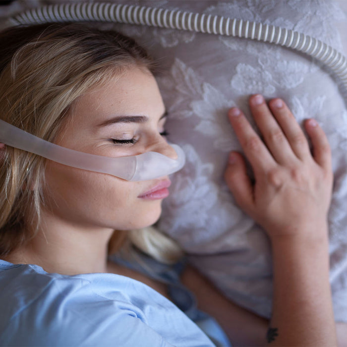 Woman sleeping with a CPAP mask