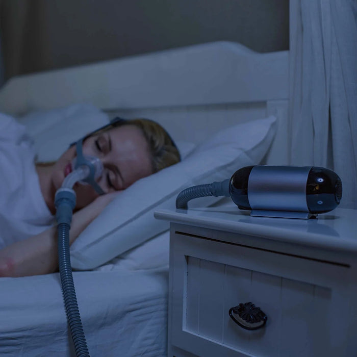 woman-in-bed-luna-travel-cpap-machine-from-react-health-westprimedirect